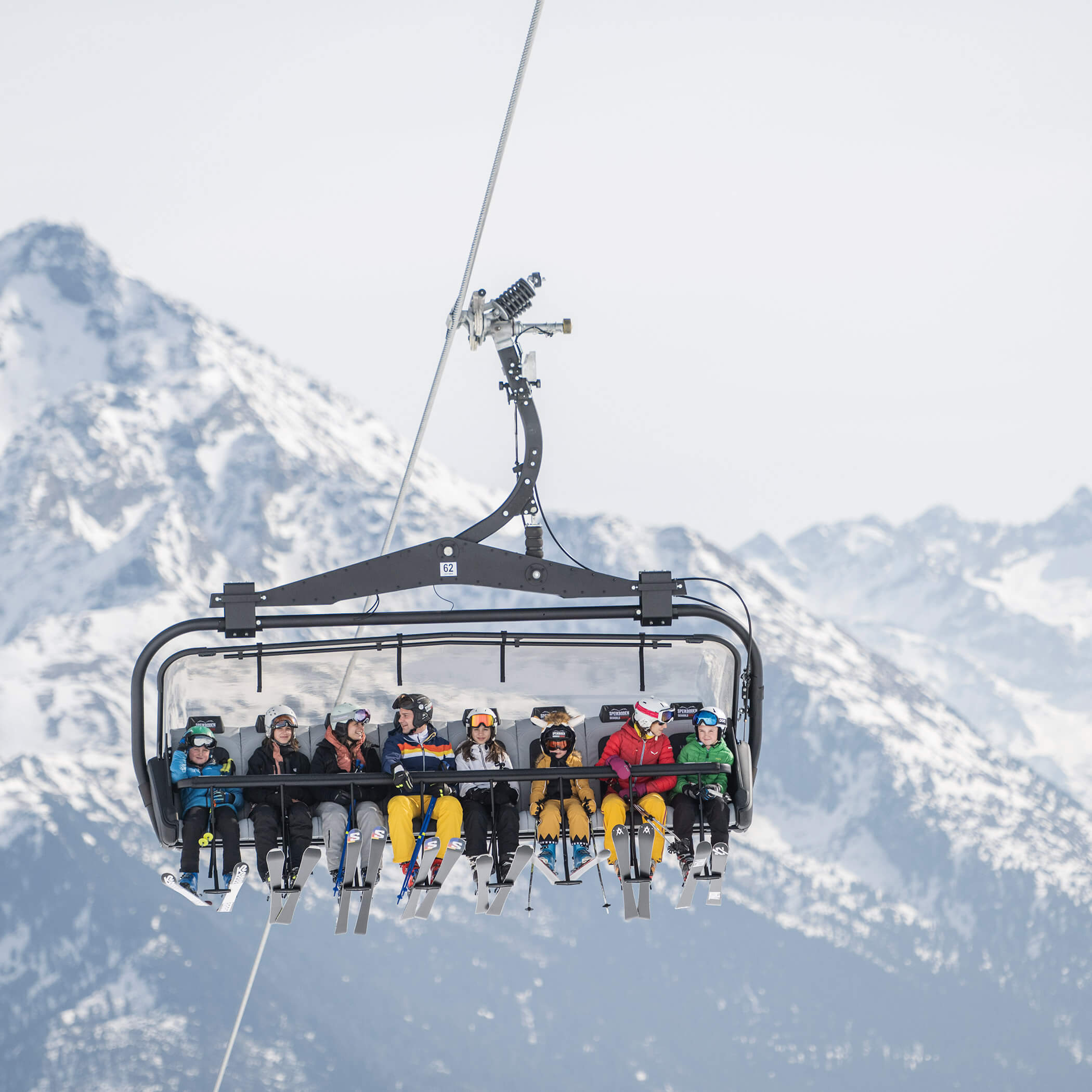 Eight skiers in the chairlift on the way to the mountain station - OLM Nature Escape