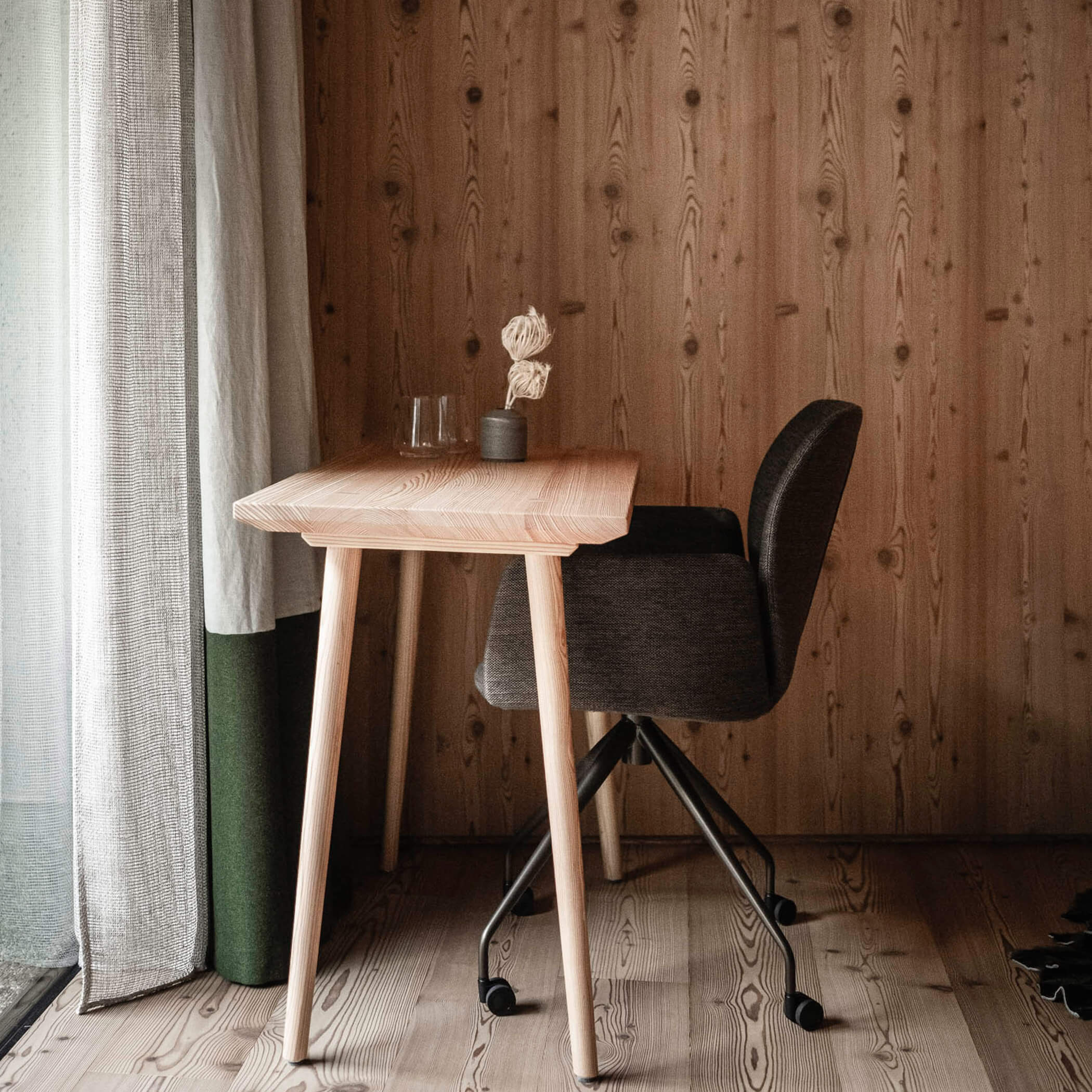 An armchair with a table in an apartment - OLM Nature Escape